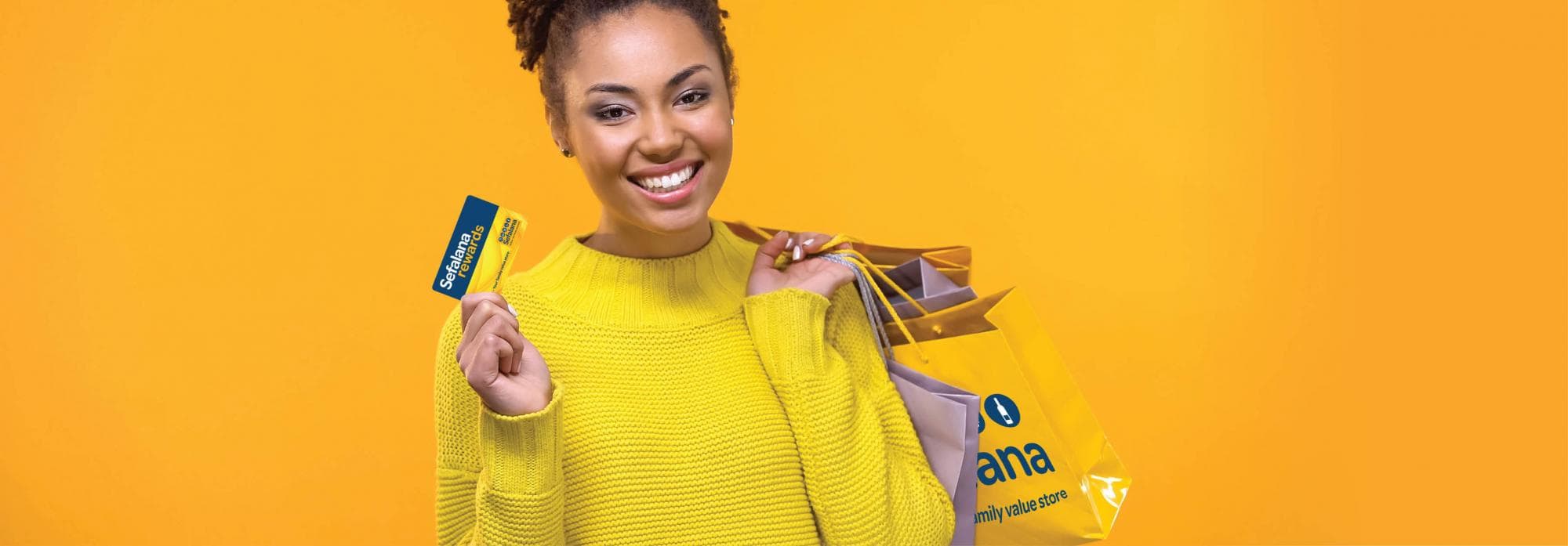 Sefalana Rewards customer with Sefalana branded shopping bag